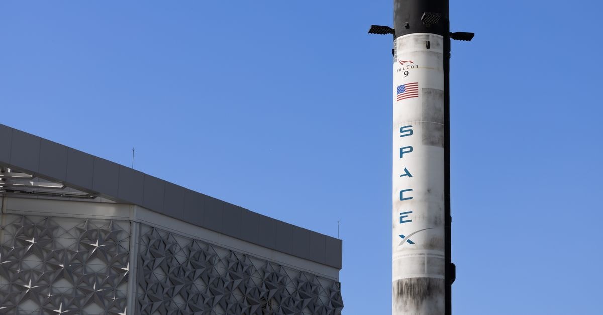 SpaceX set to release first earnings as public company, with AI spending and post-IPO slide in focus A SpaceX Falcon 9 rocket displayed outdoors against a clear blue sky in Dubai.