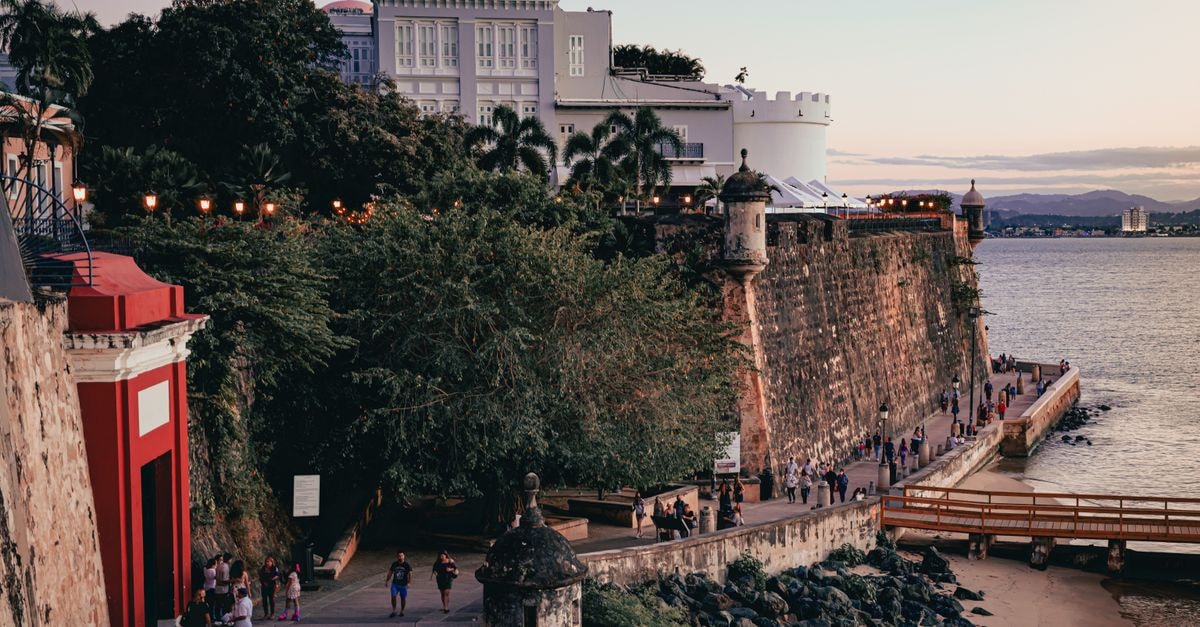 Scenic view of Old San Juan's coastal wall and paseo at sunset, Puerto Rico.