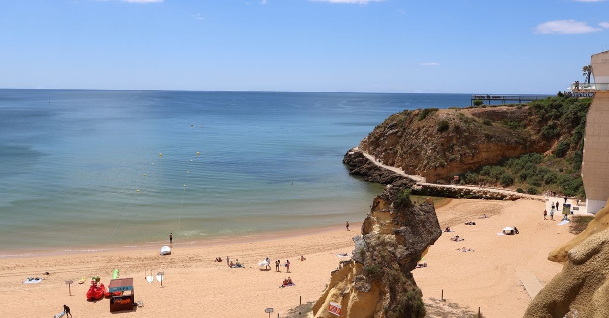 Scenic view of Praia da Rocha beach with cliffs and ocean in Algarve, Portugal.