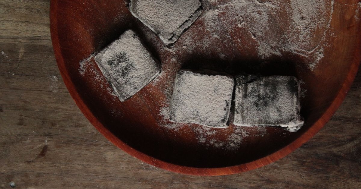 Kitchener, Clever & Cozy: A Slow-Travel Guide Wooden plate with powdered squares, offering rustic kitchen decor.