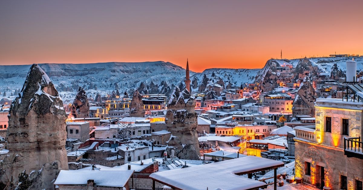 Aksaray travel guide: Cappadocia's quiet historical gateway Stunning winter sunset view of Göreme in Cappadocia, Türkiye, highlighting the unique fairy chimneys and snowy landscape.