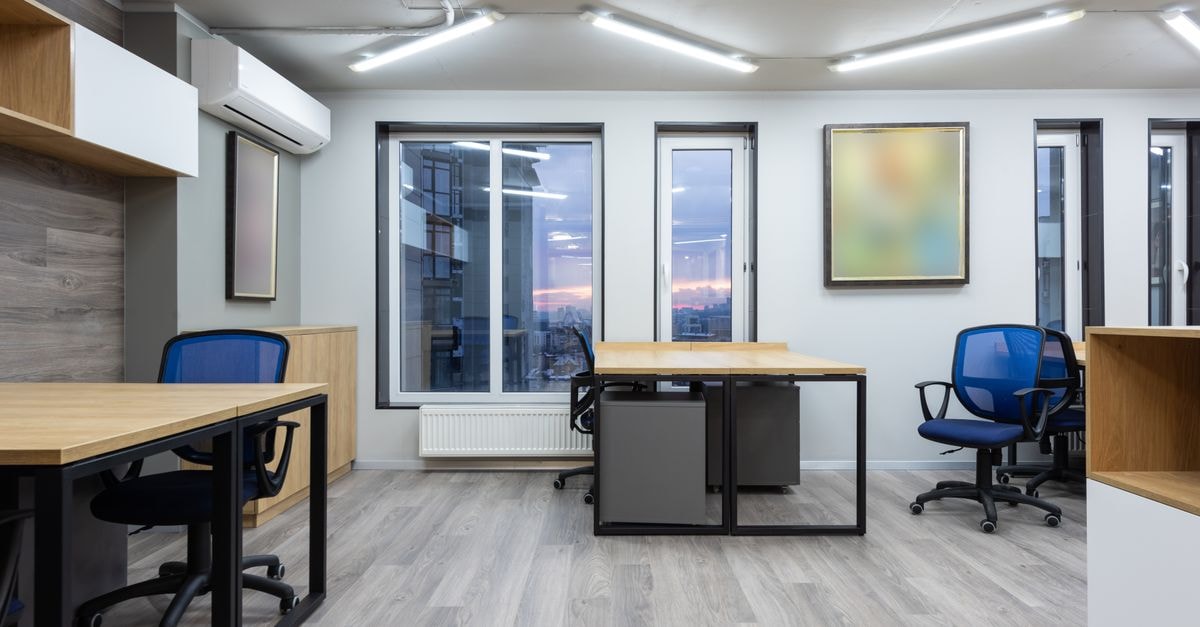 McKesson Attracts Fresh Institutional Buying as Analysts Cluster Around $1,000 Price Targets Interior of cotemporary office with wooden tables and chairs illuminated by ceiling lamps