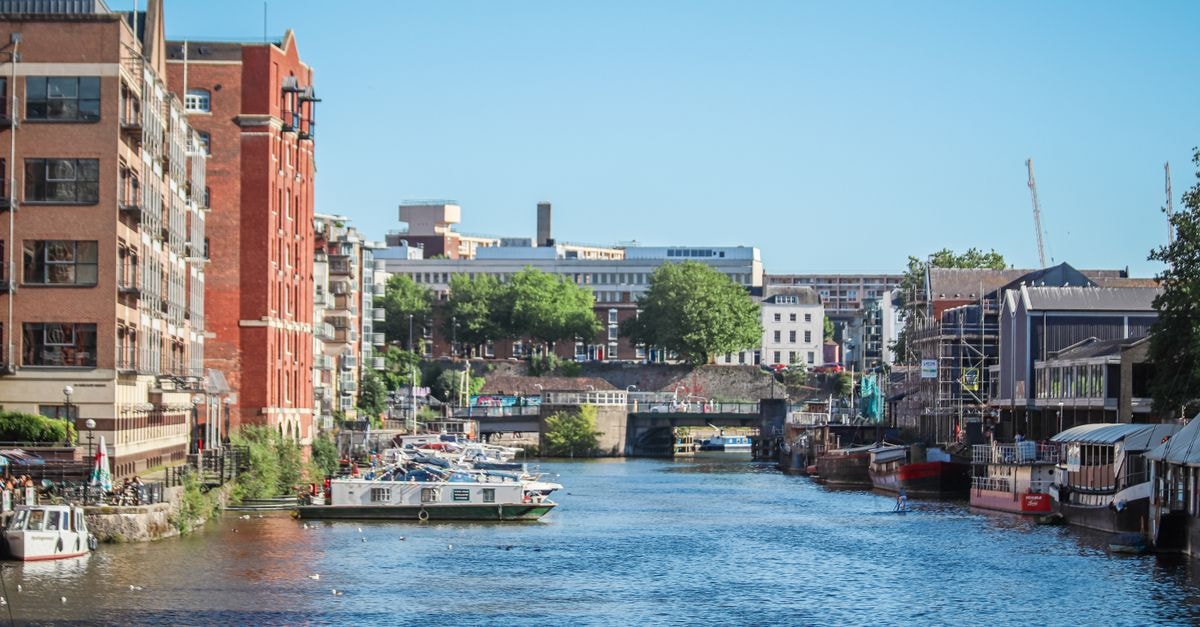Bristol travel guide: dockland creativity, food, and flow Beautiful view of a canal surrounded by buildings and boats in Bristol, England.