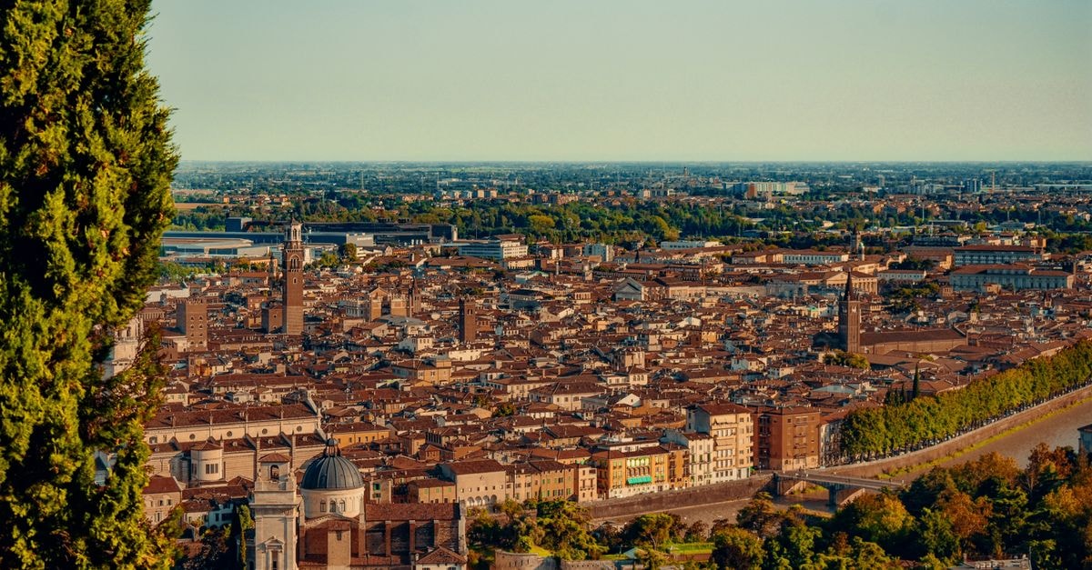 Hotel Giulietta & Romeo in Verona: A Storybook Stay Near the Arena Scenic aerial view of Verona's historic architecture and landscape under a bright blue sky.