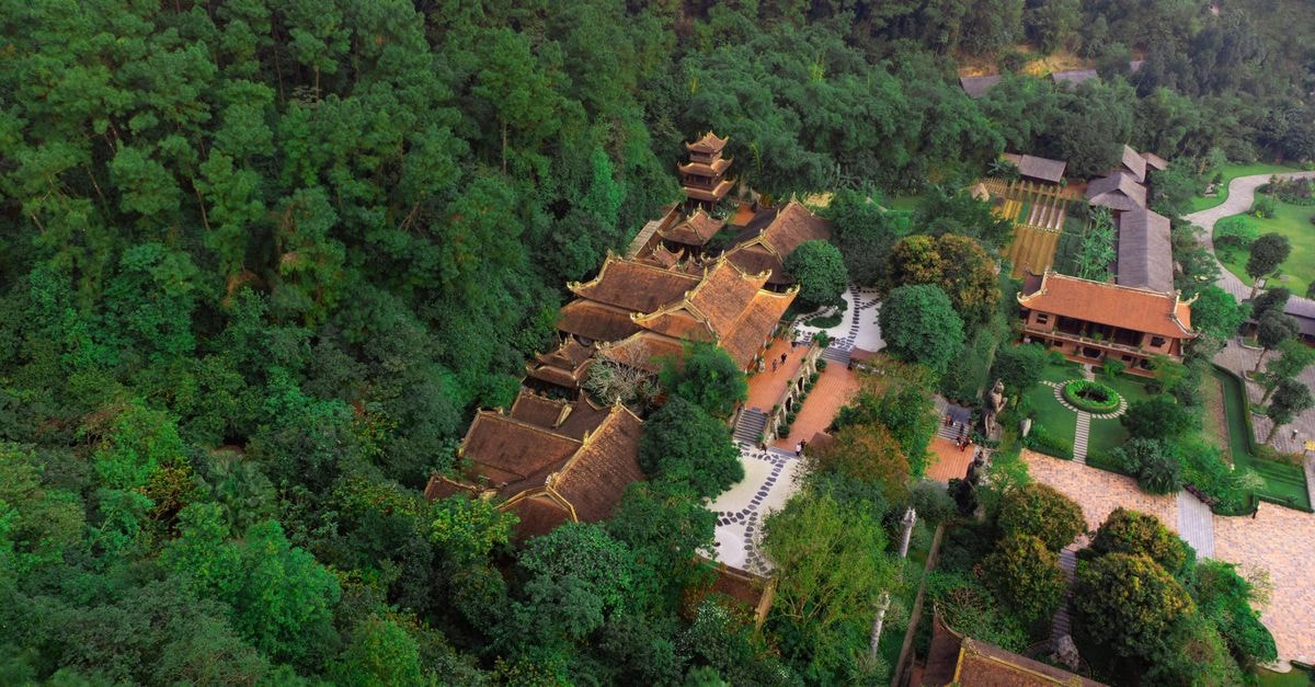 Bien Hoa Travel Guide: Planning Tips, Costs and Things to Do Aerial view of a traditional Vietnamese temple surrounded by lush greenery, capturing the serene atmosphere and architectural harmony.