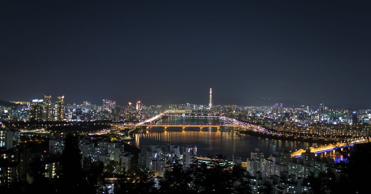 Travelodge Myeongdong City Hall in Seoul: Steps from City Hall Station Explore the dazzling night cityscape of Seoul, brightly illuminated with modern skyscrapers over the Han River.