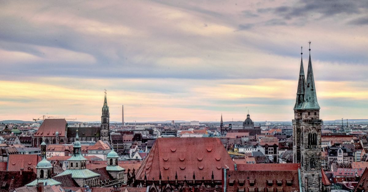 Agneshof in Nuremberg: A Quiet Hideaway on Agnesgasse A stunning view of Nuremberg's historic skyline with iconic church towers and a vibrant sky.