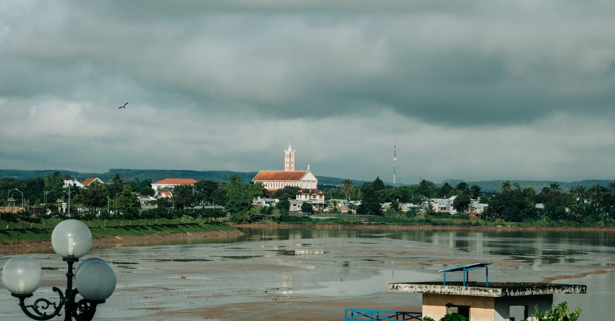 Quiet Riverside Days: A Viet Tri Travel Guide for Curious Visitors Beautiful landscape of Thahza Valley from Kon Tum, Vietnam with riverside view and moody sky.