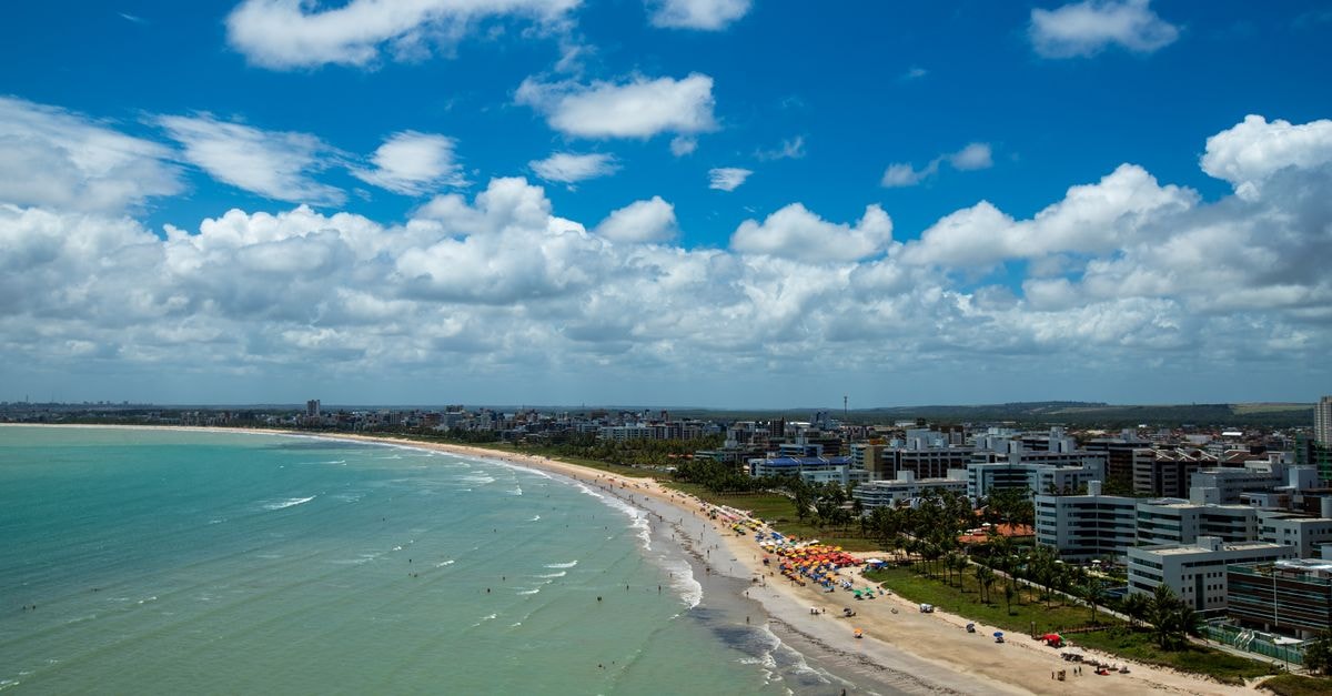 Cabo de Santo Agostinho Travel Guide: Planning Tips, Costs and Things to Do Stunning aerial view of Cabo Branco Beach in João Pessoa, Brazil featuring urban coastline and vibrant waters.