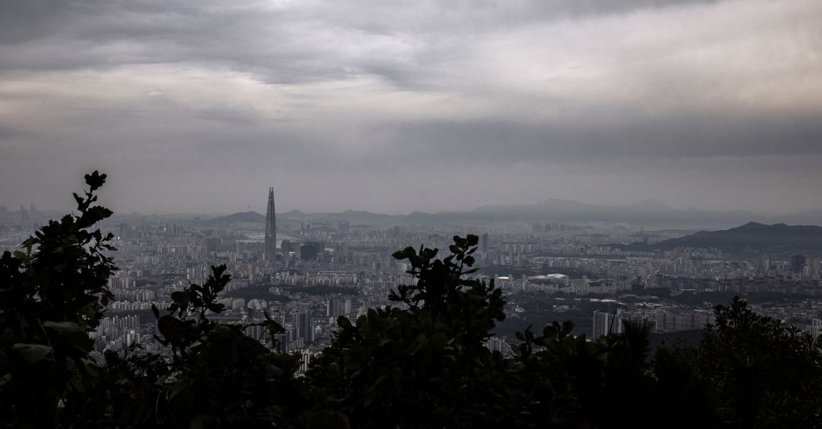 UTOP Boutique Hotel & Residence in Gwangju: A Tigers-Themed Stay Near Kimdaejung A dramatic aerial view of Gwangju cityscape with overcast skies and lush foreground.