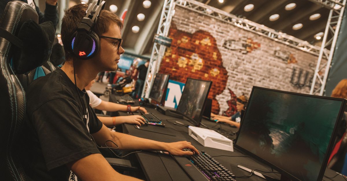 Gamescom 2026 as a playable city: dates, Cologne travel, exhibitors and games to see A young male gamer intensely focused during an esports event at an indoor gaming convention.