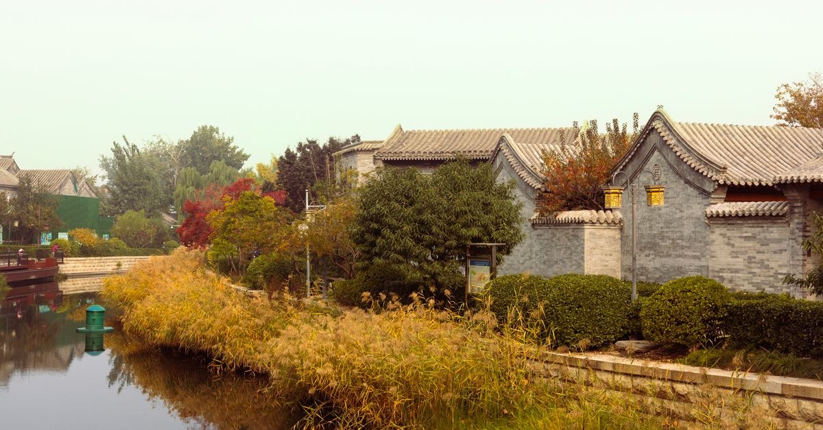 China Summer Box Office Tops 7 Billion Yuan on 22-Day Streak Traditional architecture and serene riverside landscape in Beijing, China captured on a calm day.