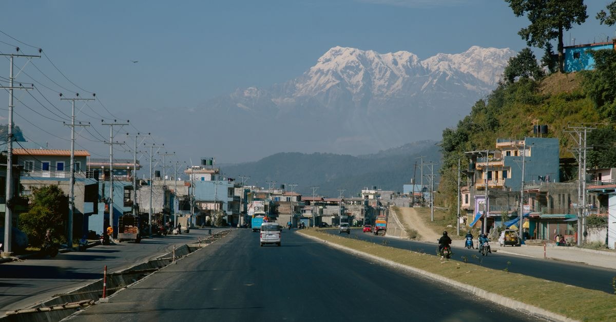 Hardik Hotel, Kathmandu: A Baghbazar Sadak Stay in the City Center A tranquil view of a road leading to the Himalayas with snow-capped peaks in the background.