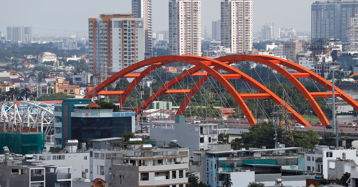 Global steel output rises 1.7% in June as India and Vietnam lead growth A vibrant urban landscape featuring a striking red bridge amid towering high-rises.