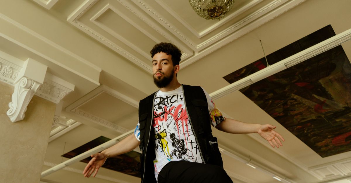 Hip-Hop Industry Observers Address Genre Shifts as Fresh Releases Hit Fashionable man posing in modern graphic streetwear indoors with a trendy look.