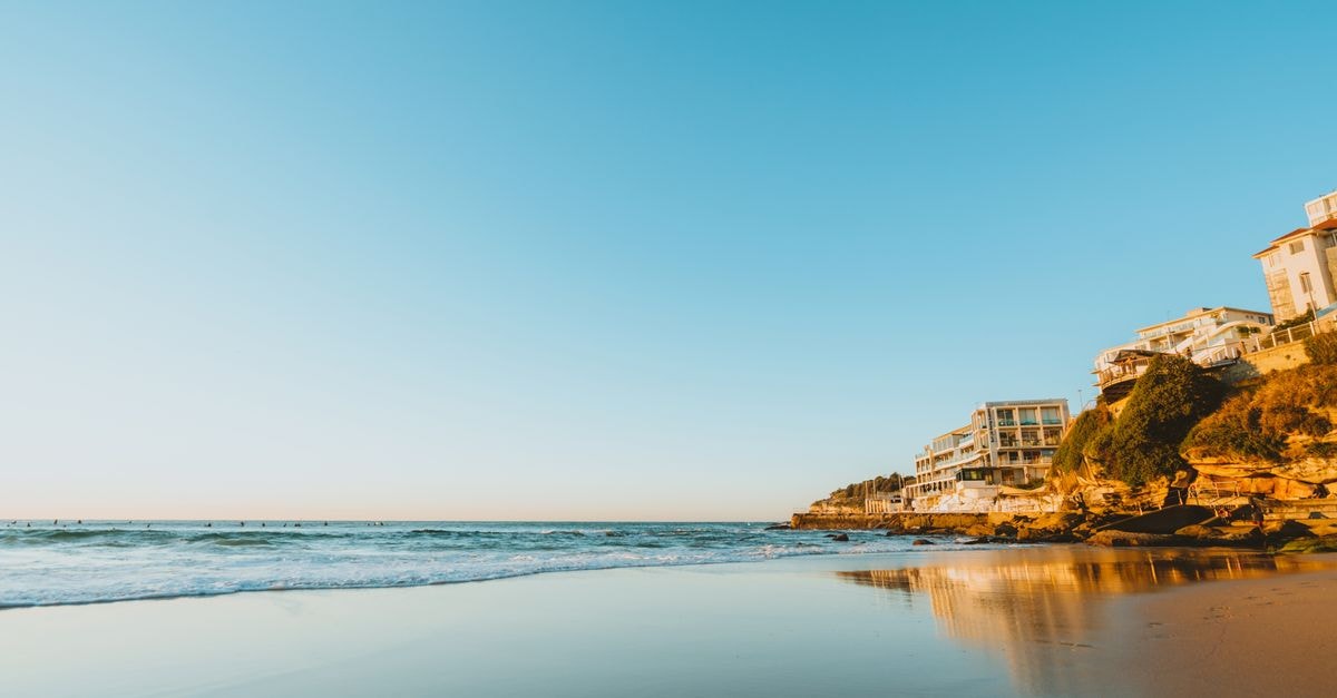 Wollongong Travel Guide: Coastal Calm Just South of Sydney Stunning sunset at Bondi Beach, showcasing ocean waves and coastal homes.