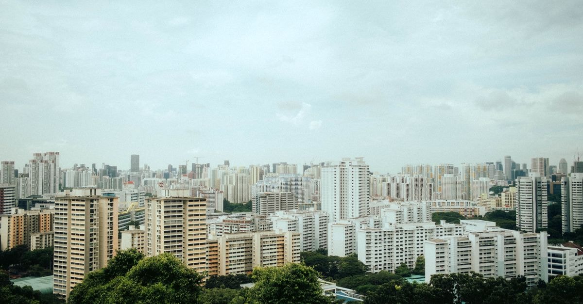 Gallop Kranji Farm Resort in Jurong West, Singapore — A Countryside Stay Near Neo Tiew Lane 2 Aerial view of Singapore's urban skyline with modern architecture amidst greenery.