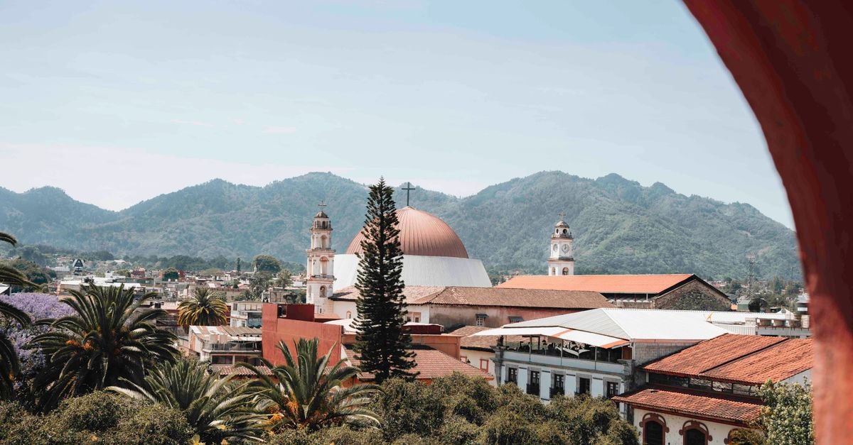 Stunning view of Huauchinango, Mexico, featuring a church and mountainous backdrop.