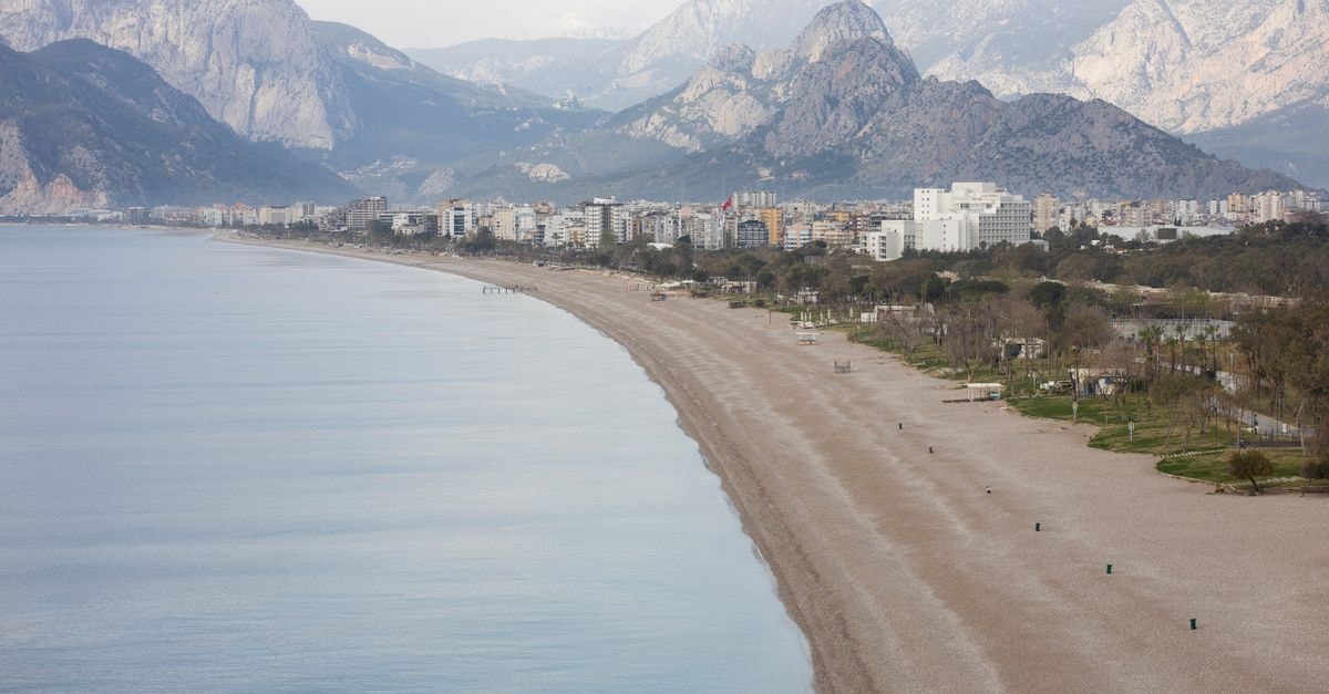 Peaceful beach in Antalya with the Taurus Mountains in the background.