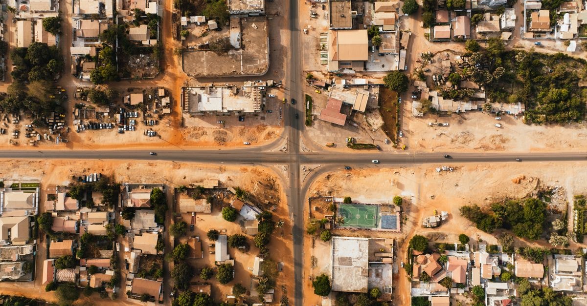 Aerial view of a city's grid layout with buildings and roads intersecting.