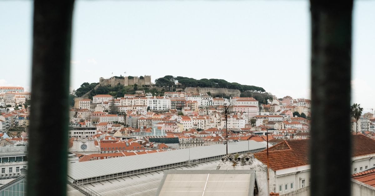 Novotel Setúbal in Setúbal: Gateway to the Sado Estuary View through bars of Lisbon's Alfama district with São Jorge Castle.