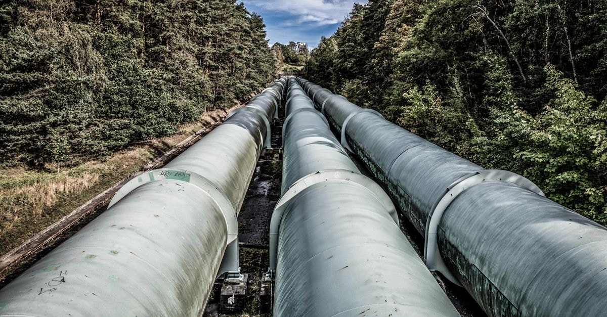 Energy Services of America: Cycle Hint, Capital Question, Price Premium View of large industrial pipelines running through a lush forest landscape.