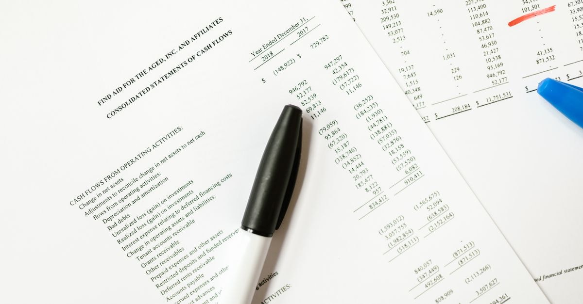 ExxonMobil reports third-quarter profit above analyst estimates Financial documents featuring cash flows and pens, ideal for business themes and analysis.