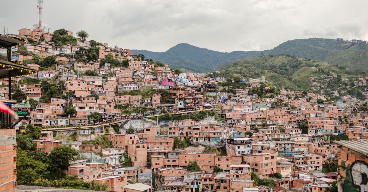Explore the vibrant and densely packed hillside homes of Medellín, Colombia, a testament to the city's colorful culture and unique architecture.