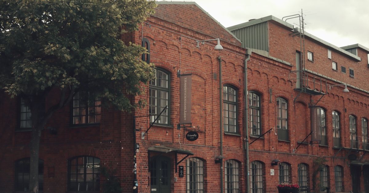 A vintage red brick industrial building in Jönköping, Sweden, showcasing architectural history.