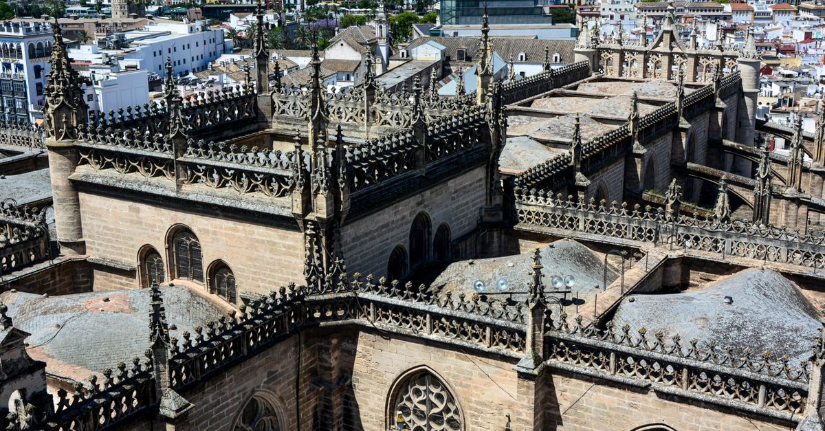 Hotel Vincci La Rábida, Seville — An 18th-Century Palace Stay by the Cathedral Aerial view of the intricate Gothic architecture of the Seville Cathedral with cityscape background.