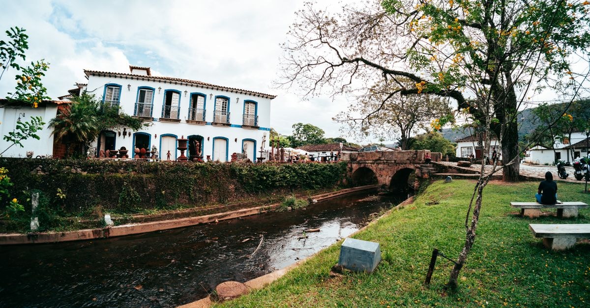 Explore colonial architecture by a scenic river in Tiradentes, Brazil.