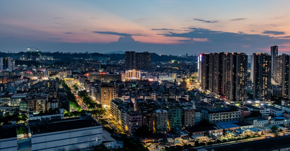 YongJiang Hotel, Nanning — A Riverside Classic Since 1973 Explore a vibrant city skyline at twilight with illuminated skyscrapers and colorful skies.
