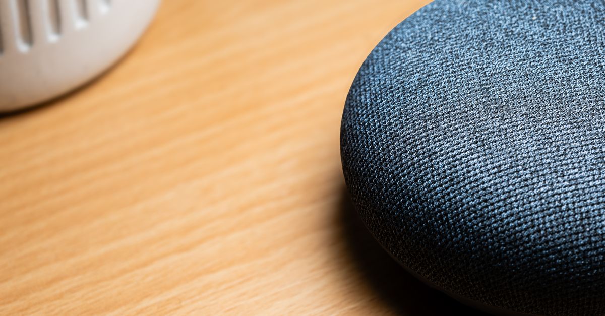 Google expands Gemini Spark to AI Pro subscribers and brings Gemini Live to early Google Home devices A close-up view of a smart speaker on a wooden table, capturing texture details.