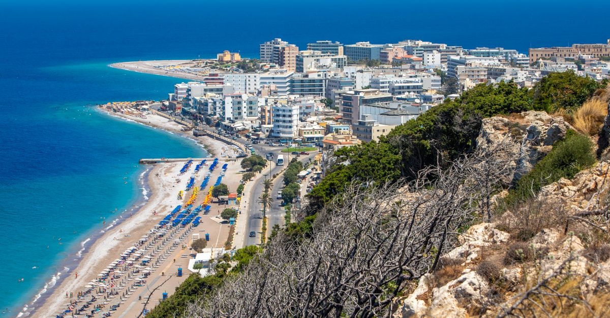 Rhodes Youth Hostel in Rhodes: Old Town Stay Inside the Medieval City Scenic aerial view of a vibrant beachfront city in Rhodes, Greece, highlighting the summer coastline.