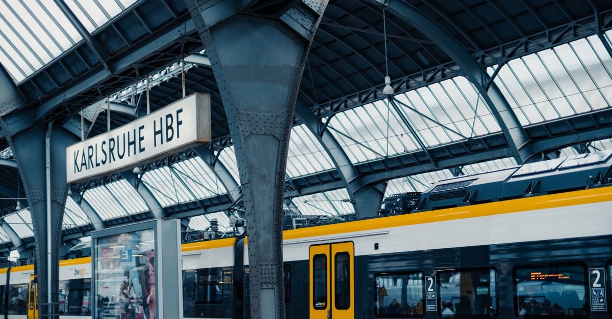 Karlsruhe Travel Guide for August 2026: Planning Tips and Costs Interior view of Karlsruhe train station featuring modern architecture and a stationary train.