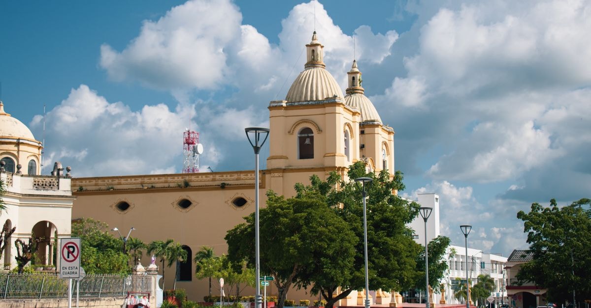 Scenic view of a Catholic church in Corozal, Colombia under a bright blue sky.