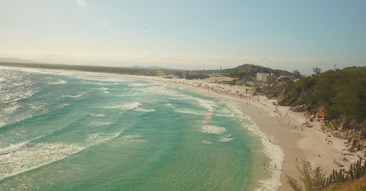 Macaé Travel Guide: Planning Tips, Costs and Things to Do A breathtaking view of Praia Grande beach in Arraial do Cabo, Brazil, showcasing turquoise waters and sandy shores.