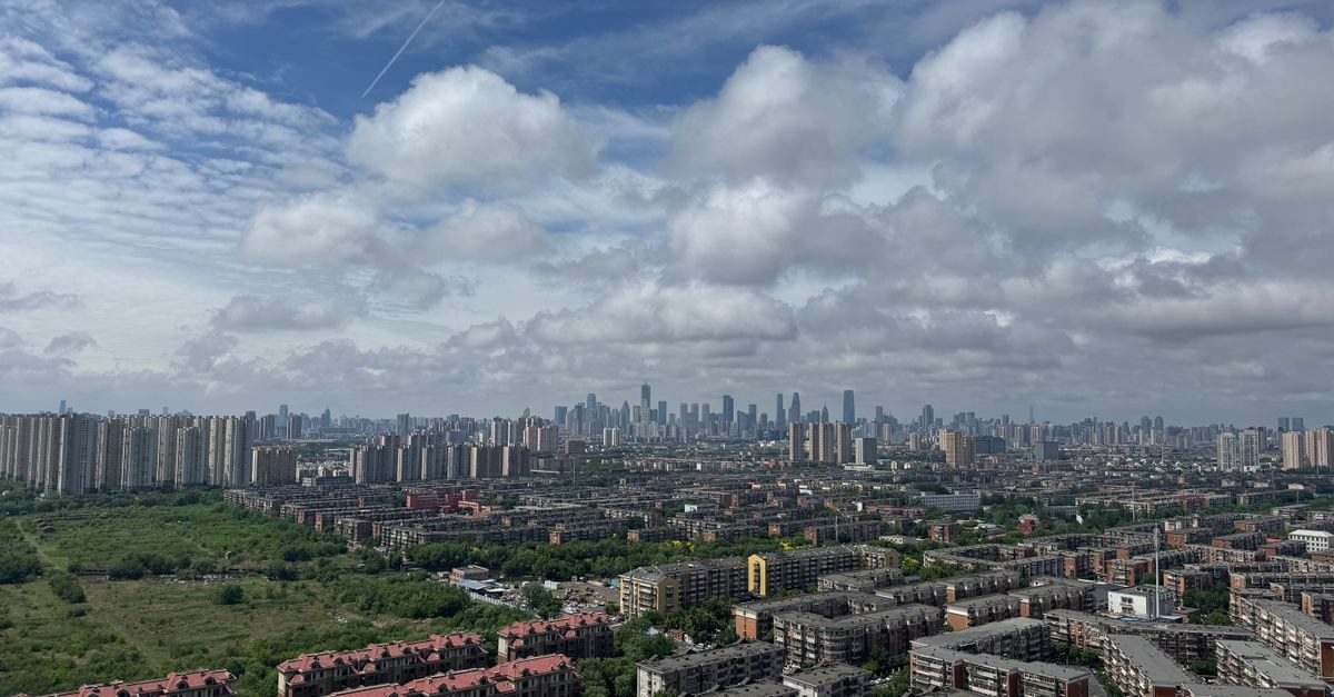 Sheraton Tianjin Hotel, Tianjin — Riverside Setting on Hexi’s Zijinshan Road High-angle cityscape of Tianjin, China on a sunny day with scattered clouds.