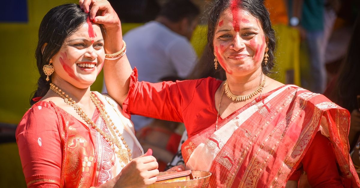 Hotel Heritage Siliguri: Elegant Rooms in a Northeast India Hub Women celebrate the traditional Sindoor Khela festival with joy and vibrant colors in Siliguri, India.