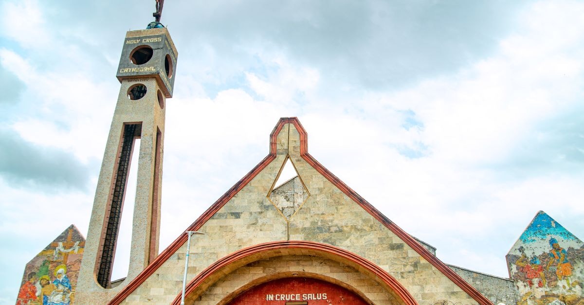 Kumasi Travel Guide: Things to Do, Eat, and Know Stunning view of Holy Cross Cathedral, Benin City, showcasing its architectural design and murals.