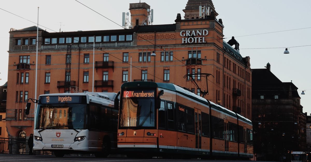 Grand Hotel in Gävle: Nordic Calm on Kyrkogatan Street view featuring a bus and cable car in front of the Grand Hotel, Norrköping, Sweden.