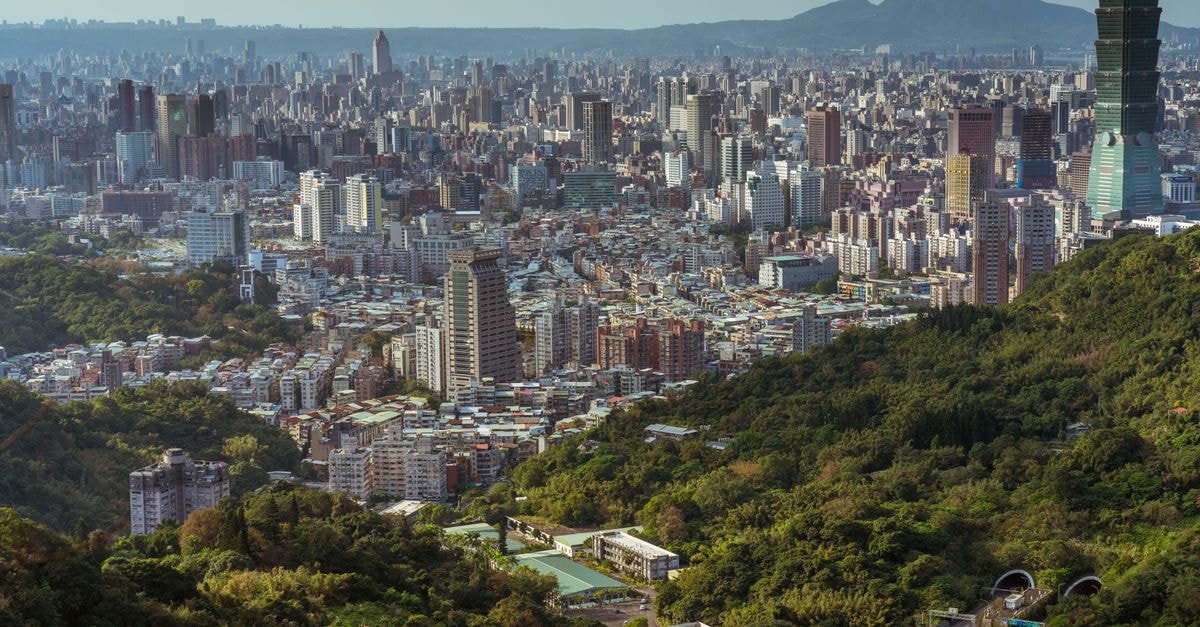 Taipei Travel Guide: Planning Tips, Costs and Things to Do A stunning aerial view of Taipei city, showcasing the urban skyline and Taipei 101.