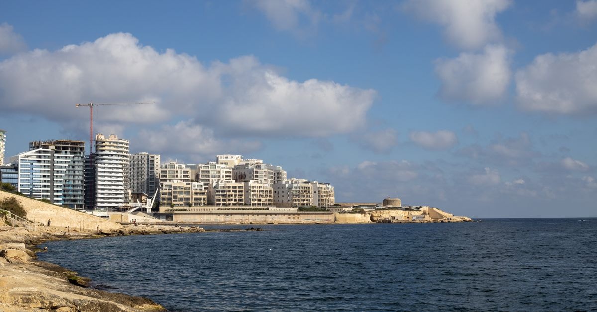 Preluna Hotel in Sliema: A 1969 Seafront Story on Tower Road Skyline view of modern buildings along the coast with a clear blue sky and calm sea.