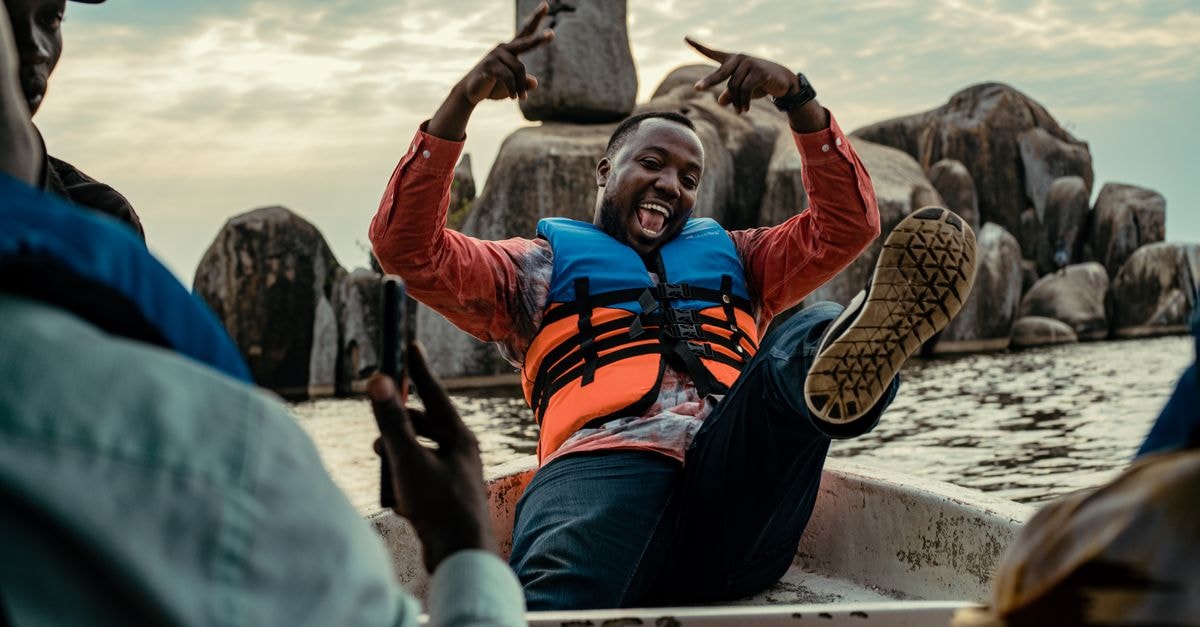 A Slow-Lake Travel Guide to Musoma, Tanzania A group enjoying a playful boat ride near Bismark Rock on Lake Victoria, Tanzania.