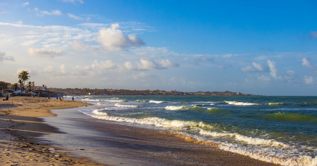 Beautiful sandy beach under blue sky in Maxaranguape, Brazil, capturing the essence of tranquility.