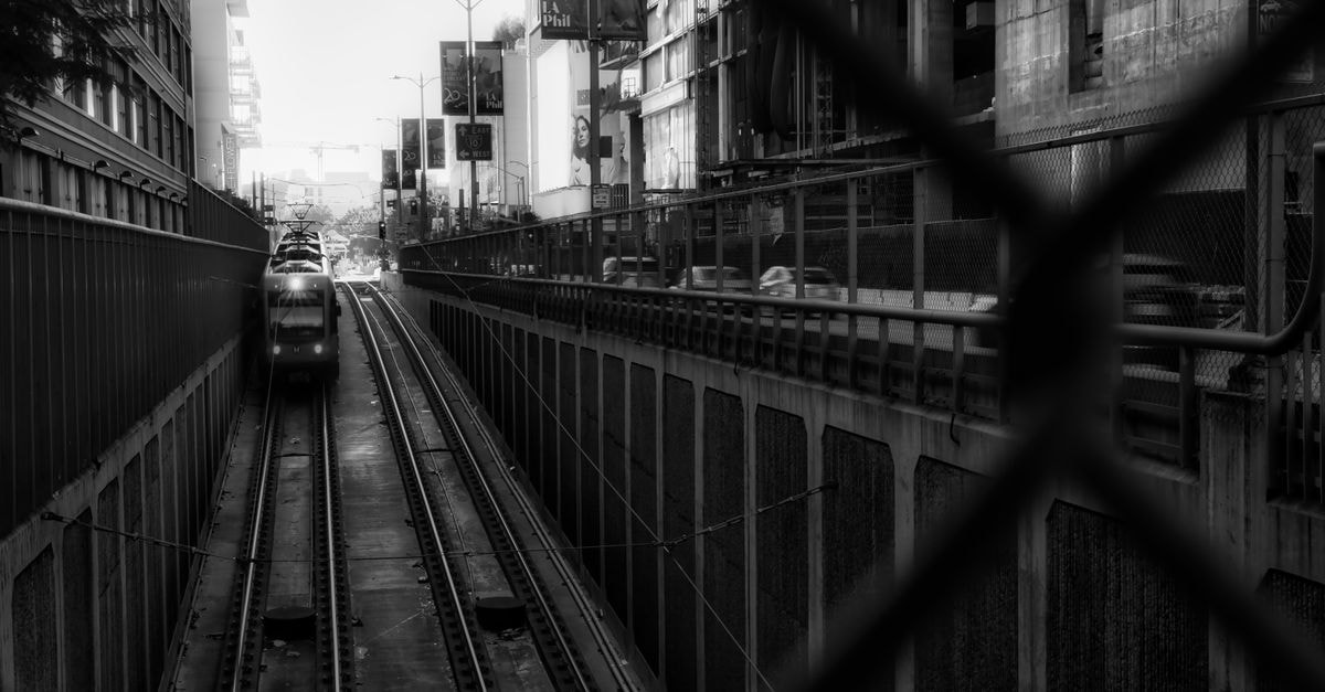 Los Angeles Travel Guide: Weather, Transit, and Food Context Black and white photo of a train in a Los Angeles urban tunnel with cityscape above.