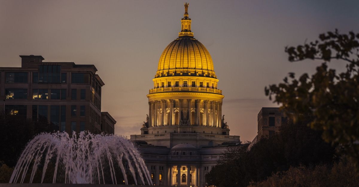 The Wisconsin State Capitol illuminated during twilight, showcasing its architectural beauty.