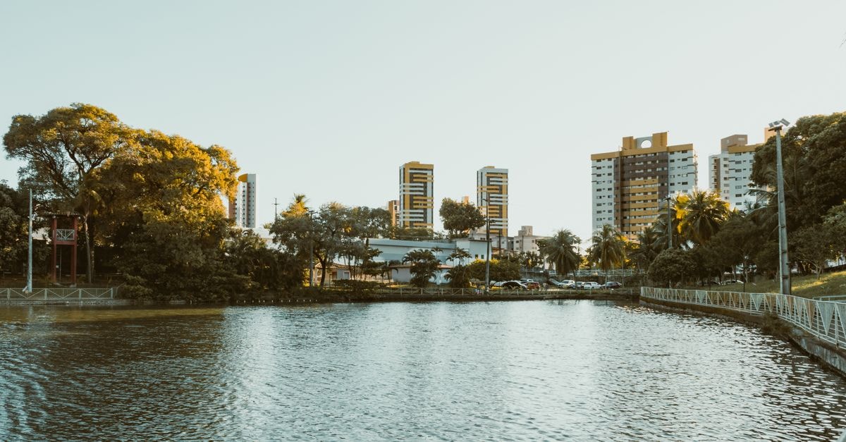 Campo Grande Travel Guide: Planning Tips, Costs and Things to Do Scenic view of a waterfront with modern buildings in Natal, RN, Brazil during a sunny day.