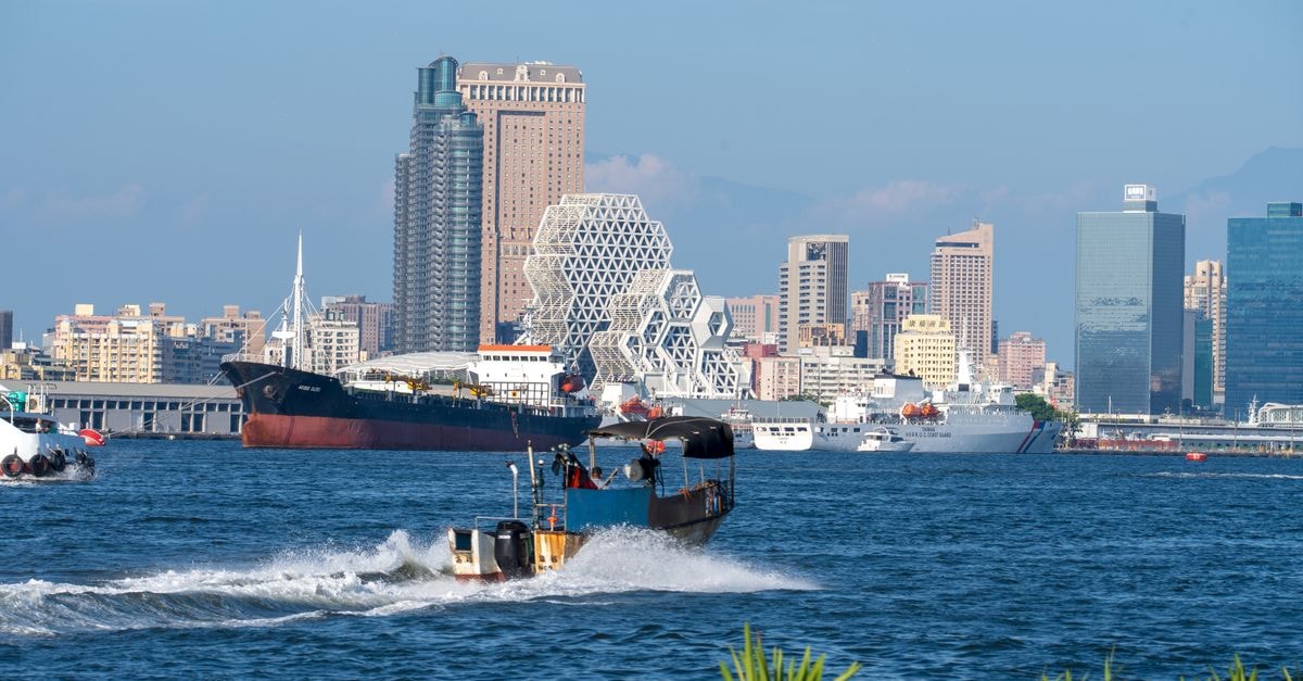 The Lees Hotel, Kaohsiung City: A Quiet Base on Wufu 1st Road A cityscape of Kaohsiung Harbor showcasing iconic geometric architecture and bustling maritime activity.