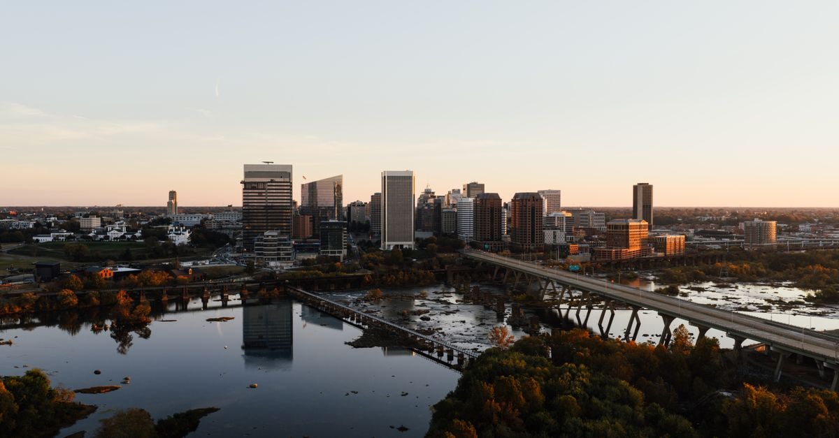 Motel 6 Augusta, ME: A Practical Stop on Edison Drive Stunning aerial shot of Richmond, Virginia skyline with river reflection at sunset.